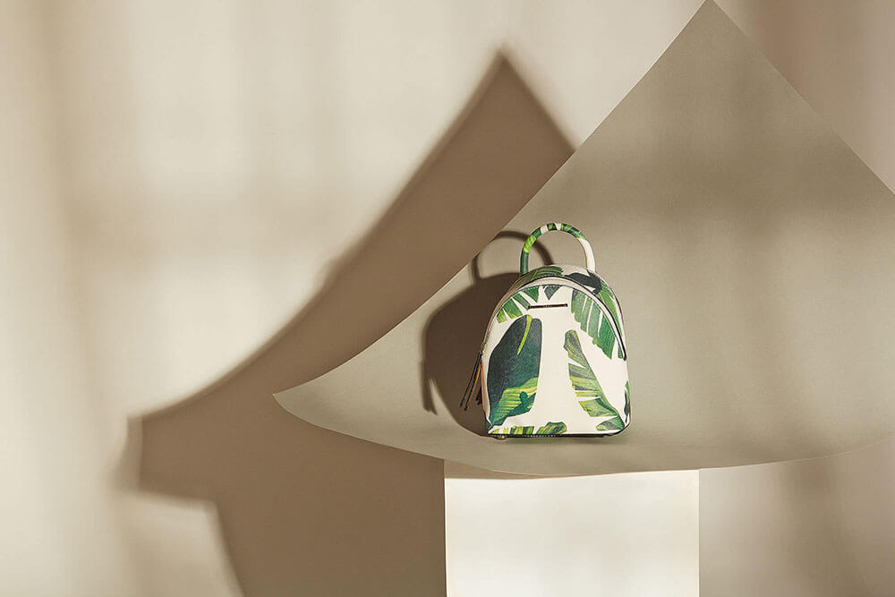 Flatlay product photography - White leather bag with leaf prints - Mount Studio